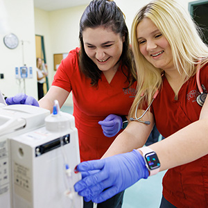 Nursing students operating equipment